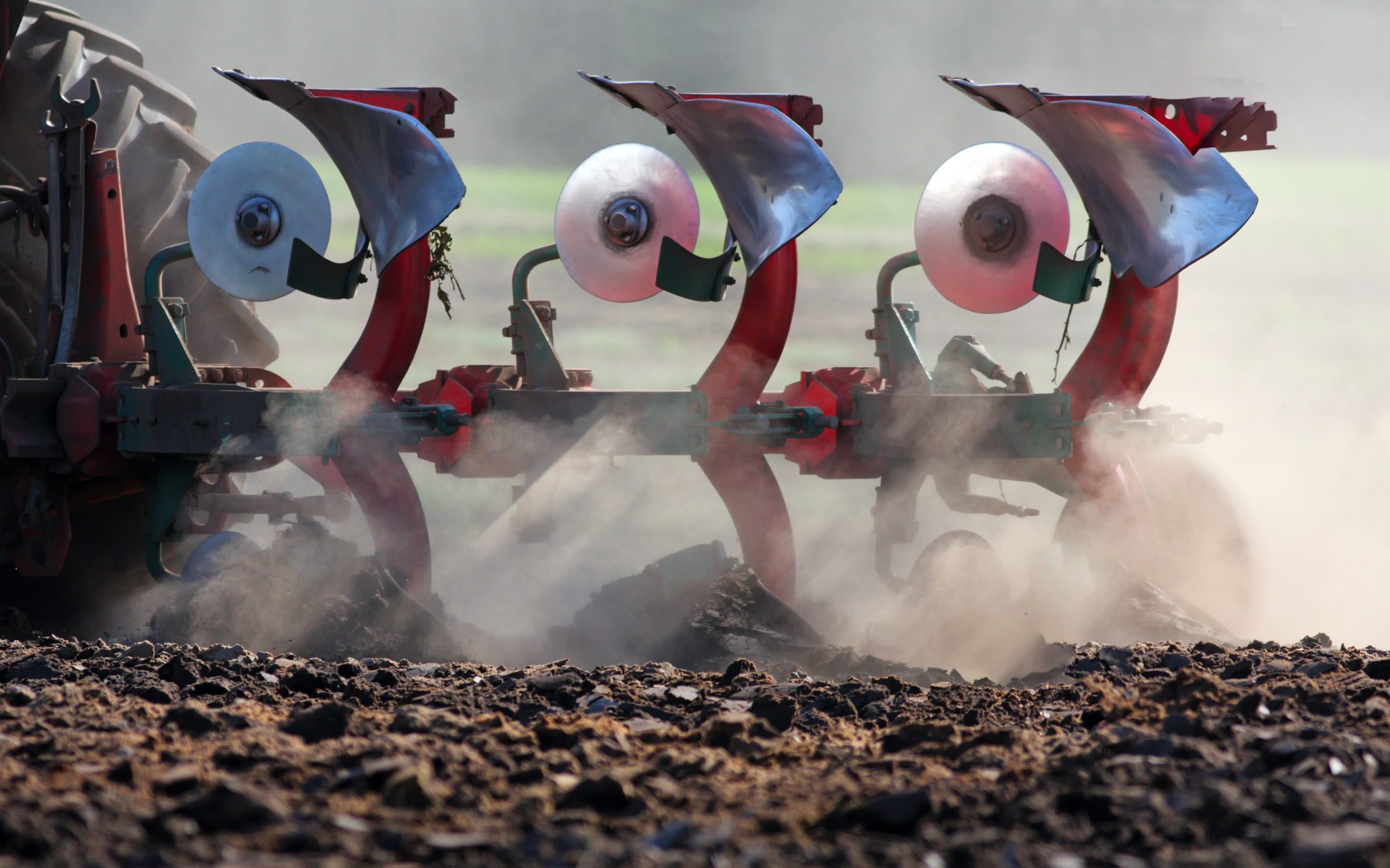 A close-up of a farmer’s plow in the field.