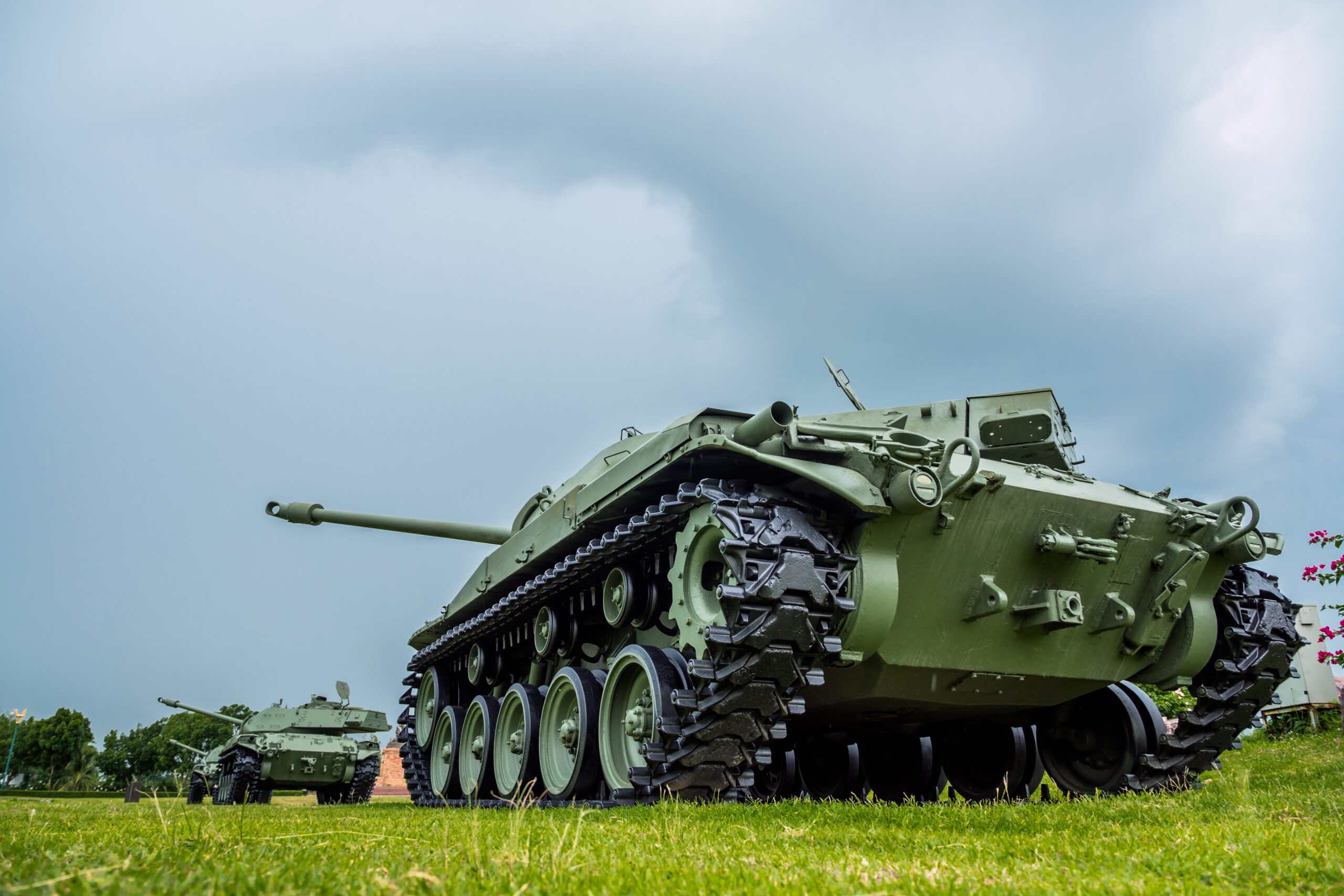 Army tanks lined up in a field.