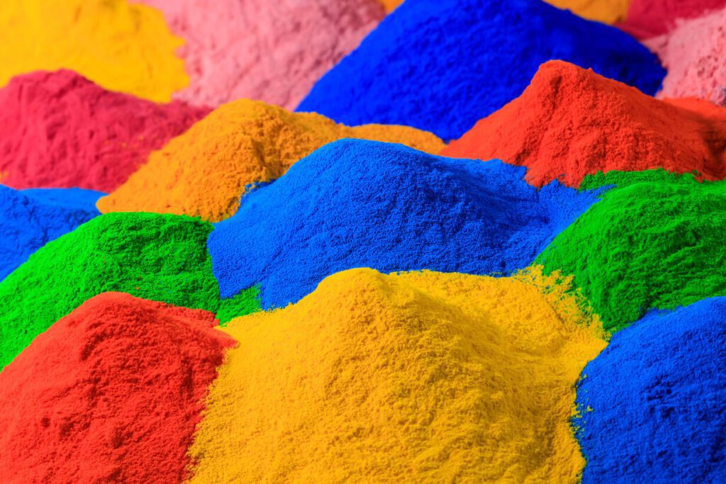 Various piles of different colors of powder for powder coating.