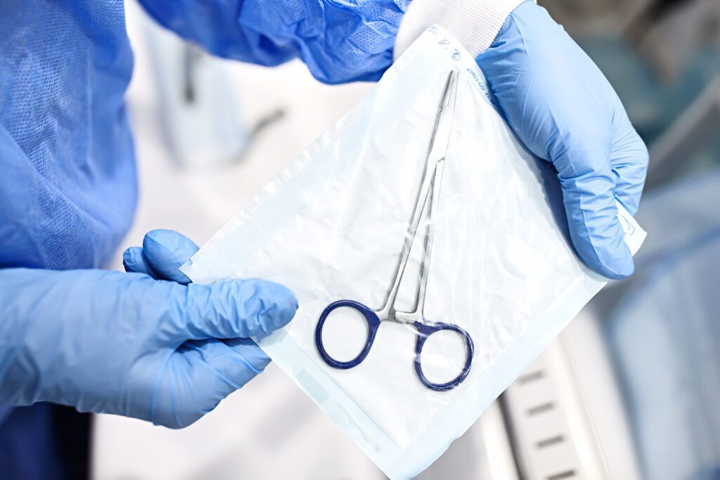 A pair of surgical clamps in a protective package after being sterilized.