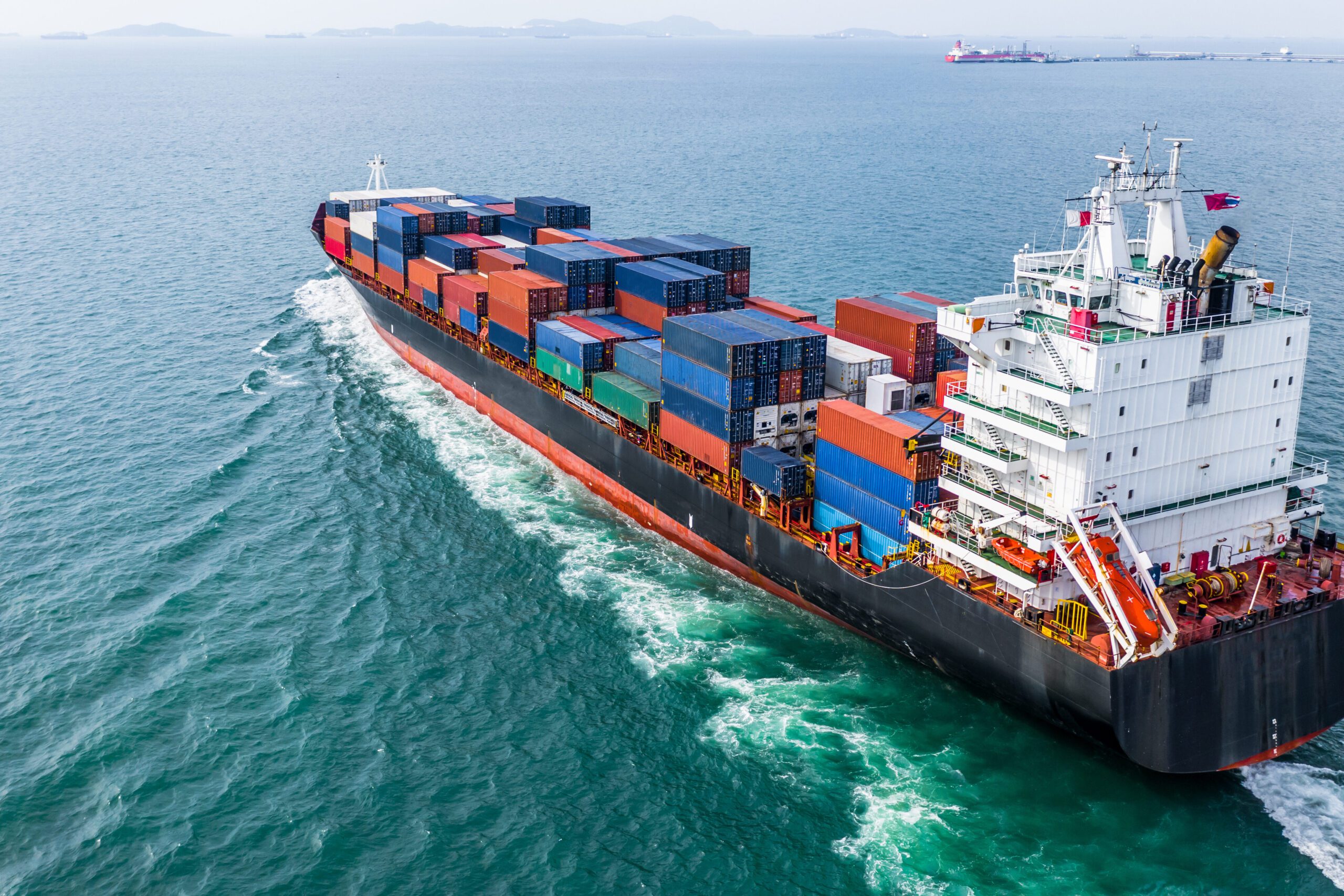 An aerial view of a cargo container shipping sailing.