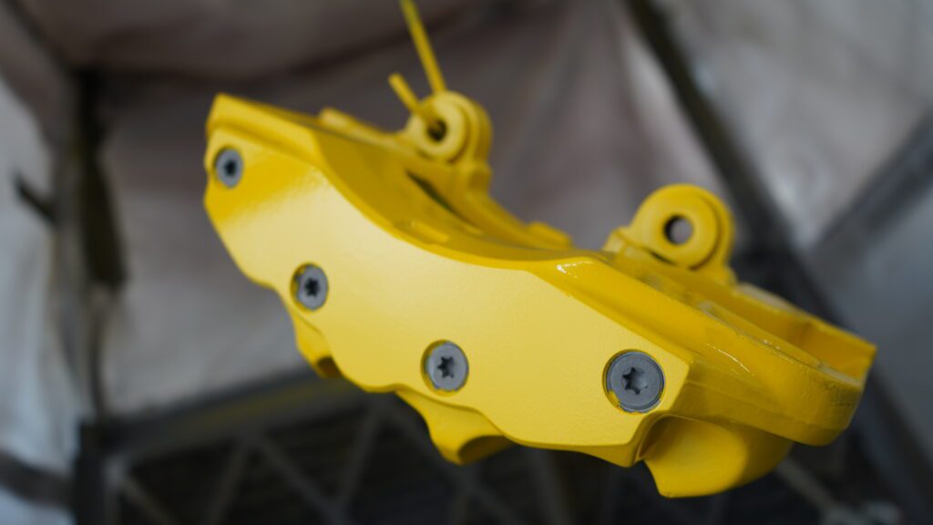 Yellow powder-coated brake calipers.