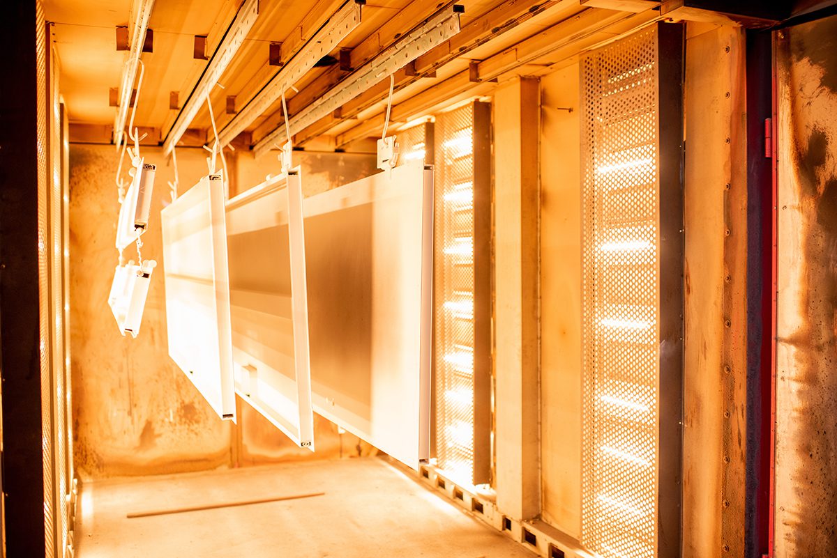 Metal pieces curing in a powder coating oven.