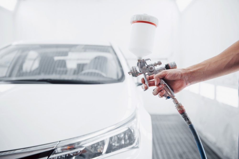 A car receiving a spray coating.