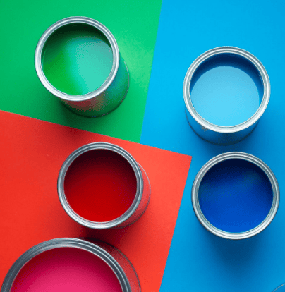 Paint cans on colored surfaces.